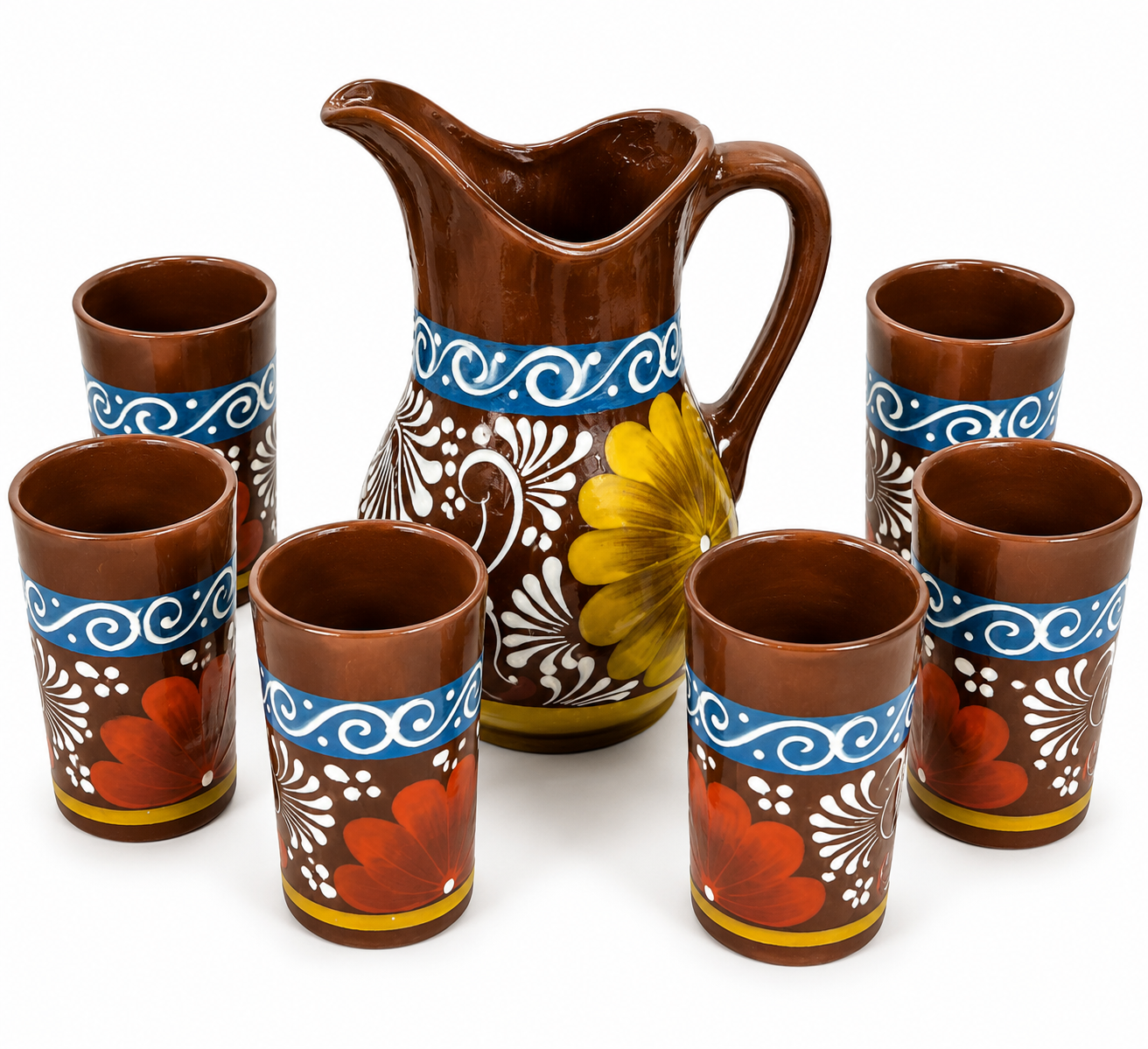 Ceramic pitcher and tumblers with floral designs on a white background