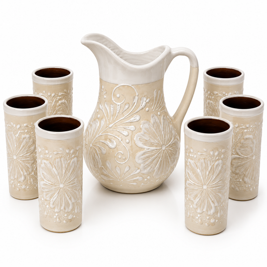 Set of ceramic pitcher and six tumblers with floral patterns on a white background