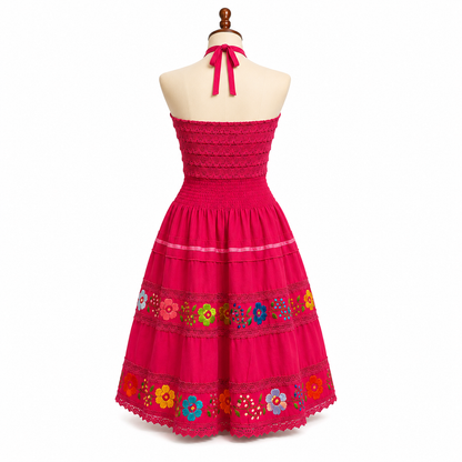 Red dress with floral embroidery on a mannequin against a white background